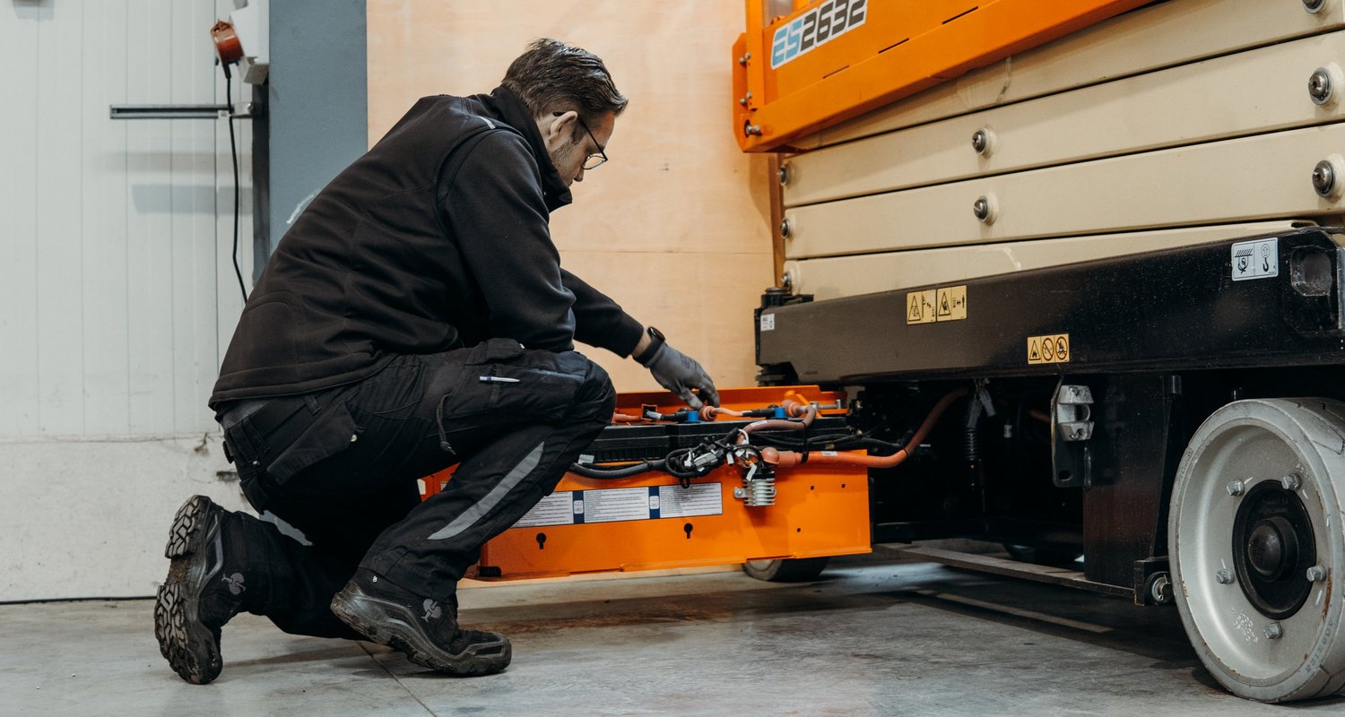 Servicetechniker wartet eine Arbeitsbühne in der Meykratec Werkstatt